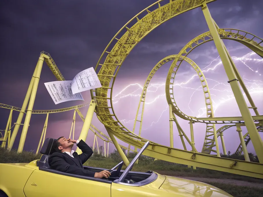 A surreal roller coaster made of financial charts, with a terrified business owner in a car.