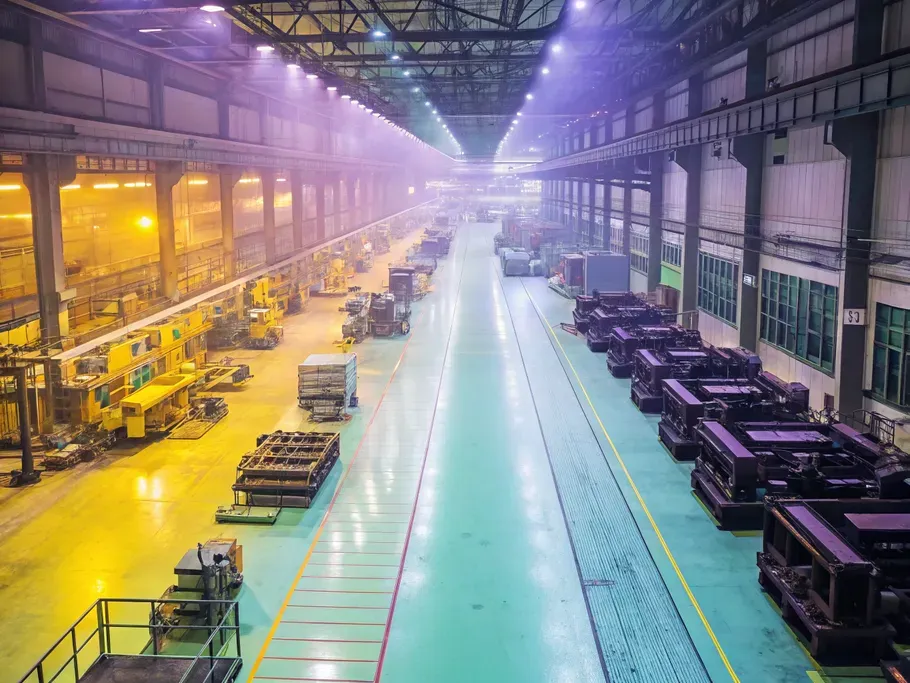 Aerial view of a pristine industrial factory floor with gleaming machinery contrasted by an overlay of aged equipment.