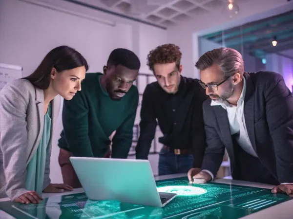 Five diverse professionals examining a glowing holographic financial statement in a modern workspace.